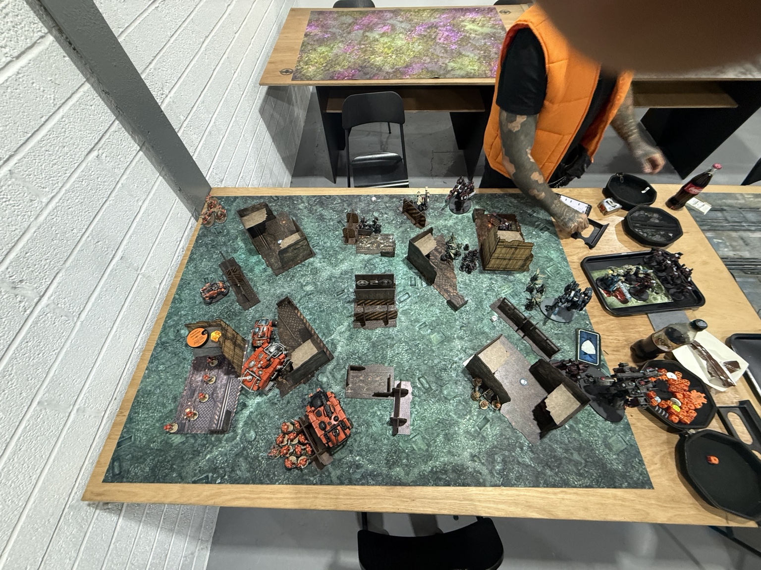Opening overhead view of James’s orange Votann vehicles and Harvey’s Tau battlesuits