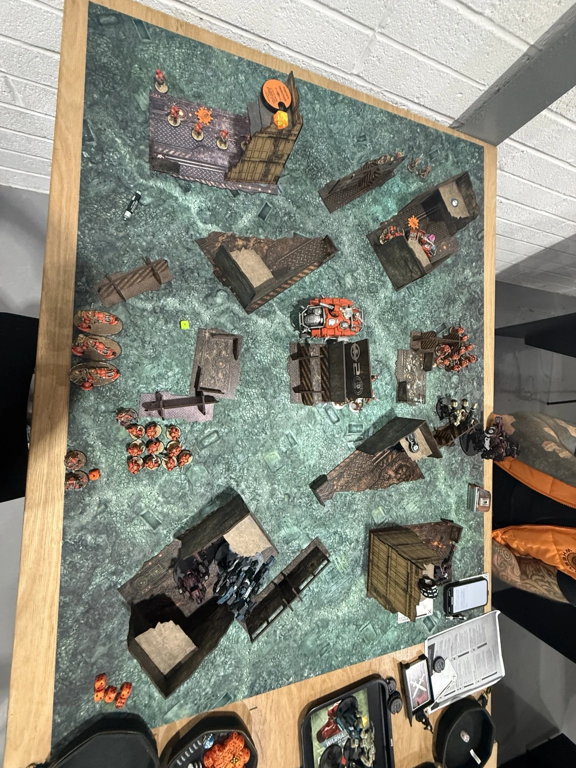 Later overhead board view showing orange infantry in the far half and the surviving central Hekaton